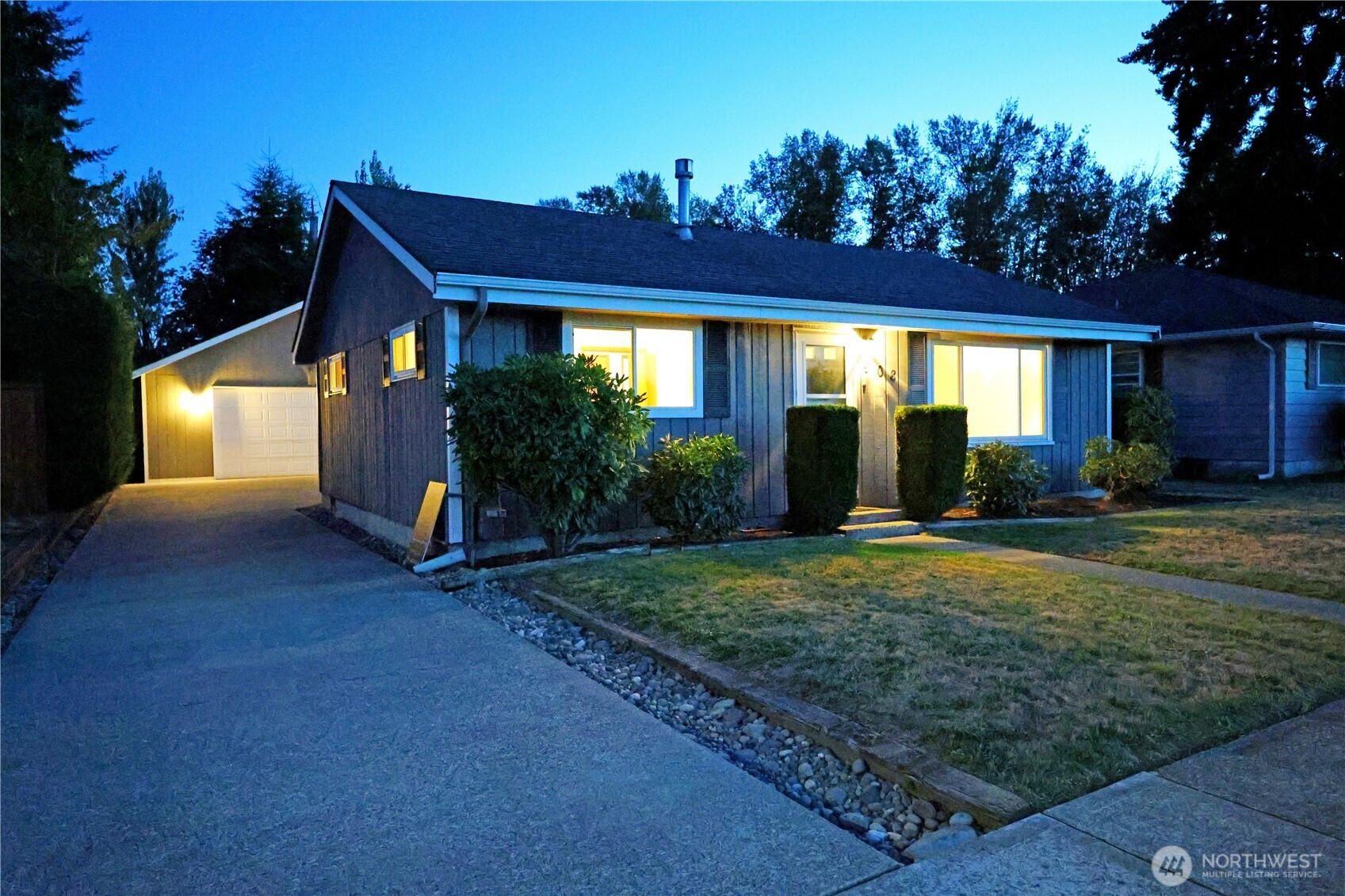 908 Willow Street Sumner, WA 98390 - Photo 28 of 32 a view of a house with brick walls and a yard with potted plants