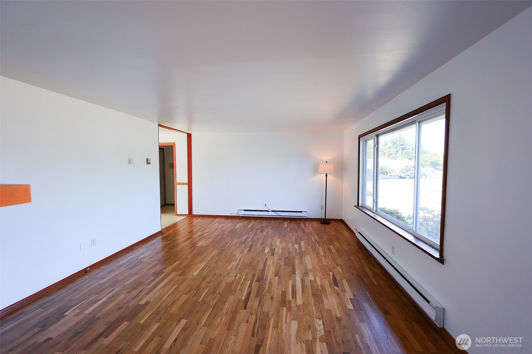 908 Willow Street Sumner, WA 98390 - Photo 5 of 32 a view of an empty room with wooden floor and a window