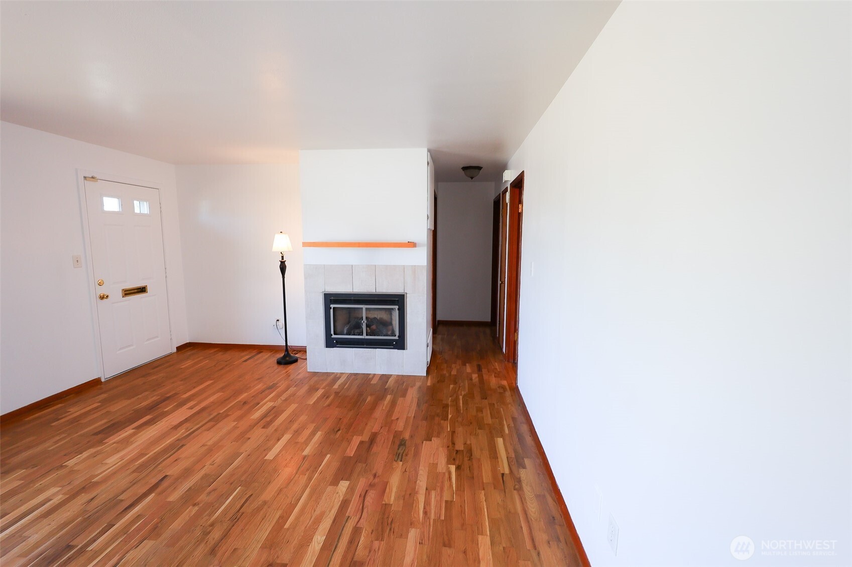 908 Willow Street Sumner, WA 98390 - Photo 6 of 32 a view of empty room with wooden floor and fireplace