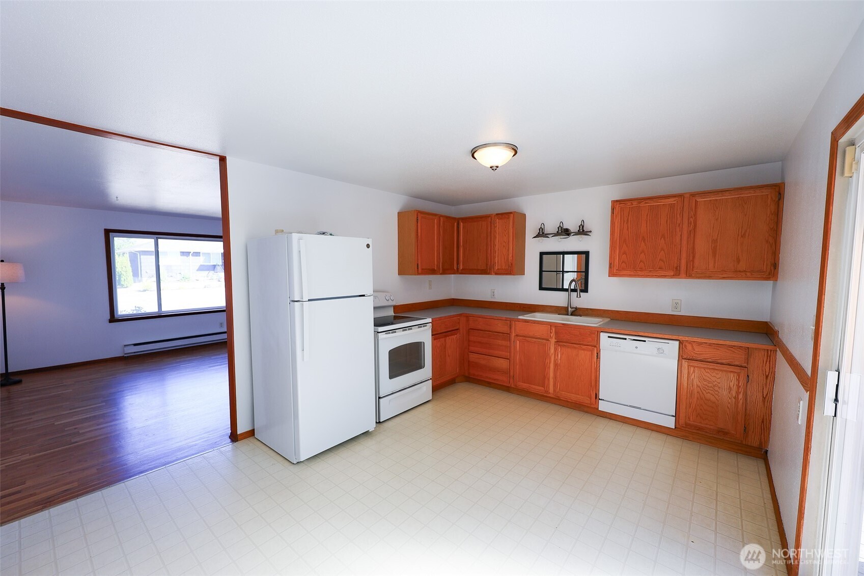908 Willow Street Sumner, WA 98390 - Photo 7 of 32 a kitchen with stainless steel appliances a refrigerator sink and cabinets