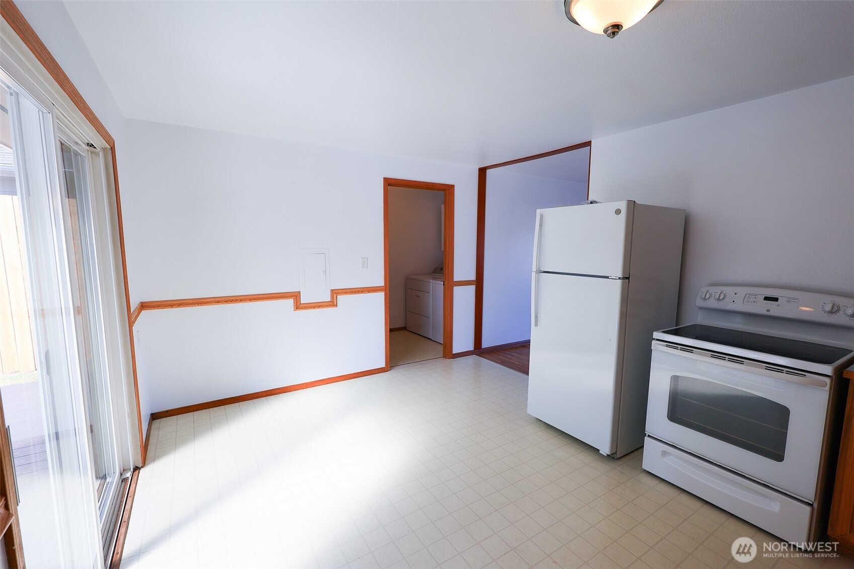 908 Willow Street Sumner, WA 98390 - Photo 9 of 32 a view of an empty room with a refrigerator