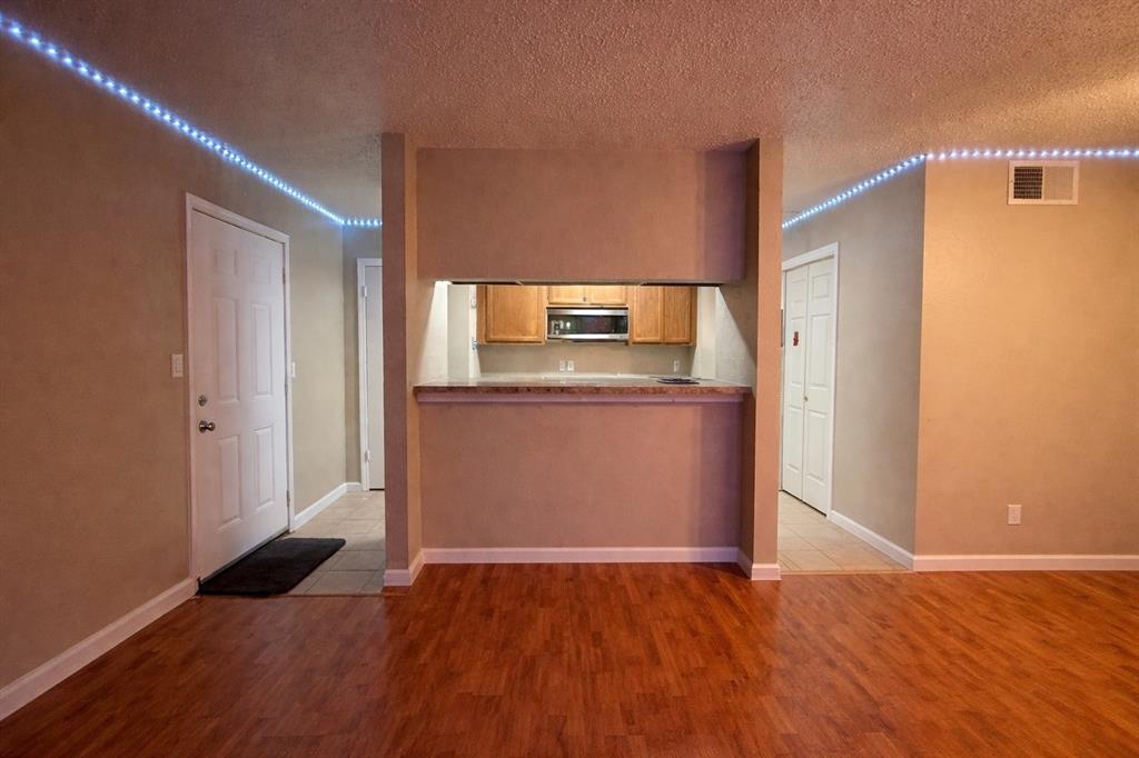 18333 Roehampton Drive, Unit 1117 Dallas, TX 75252 - Photo 3 of 14 a view of a kitchen from a hallway