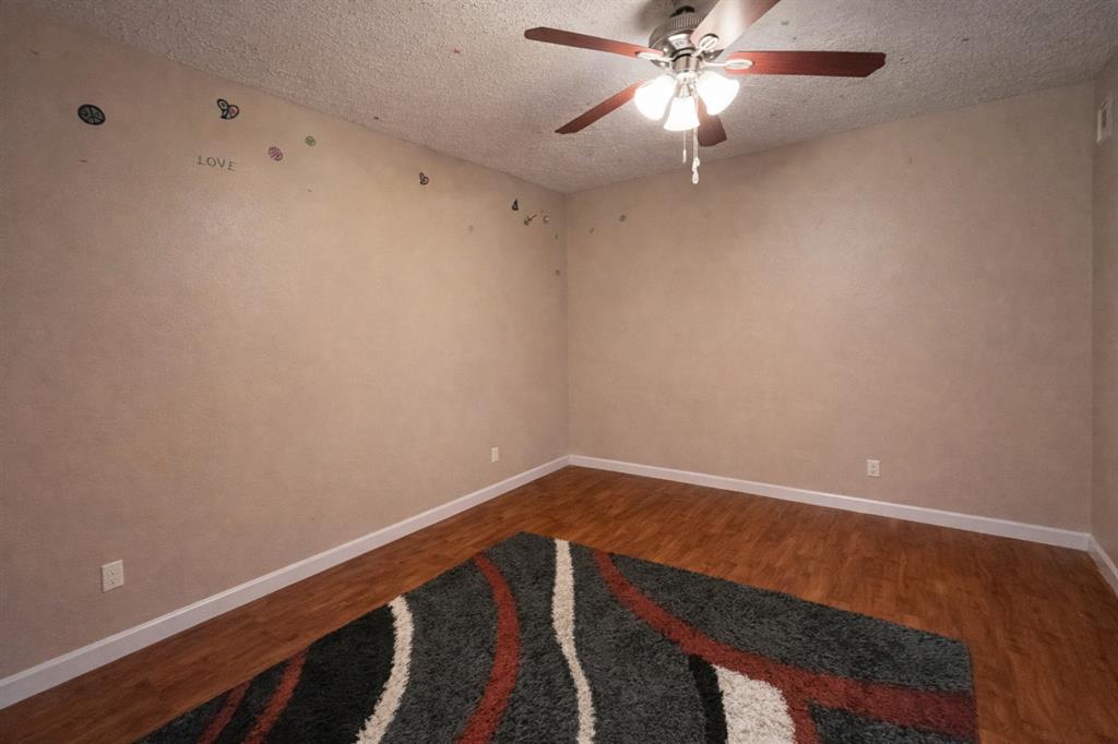 18333 Roehampton Drive, Unit 1117 Dallas, TX 75252 - Photo 6 of 14 a view of wooden floor and chandelier fan in a room