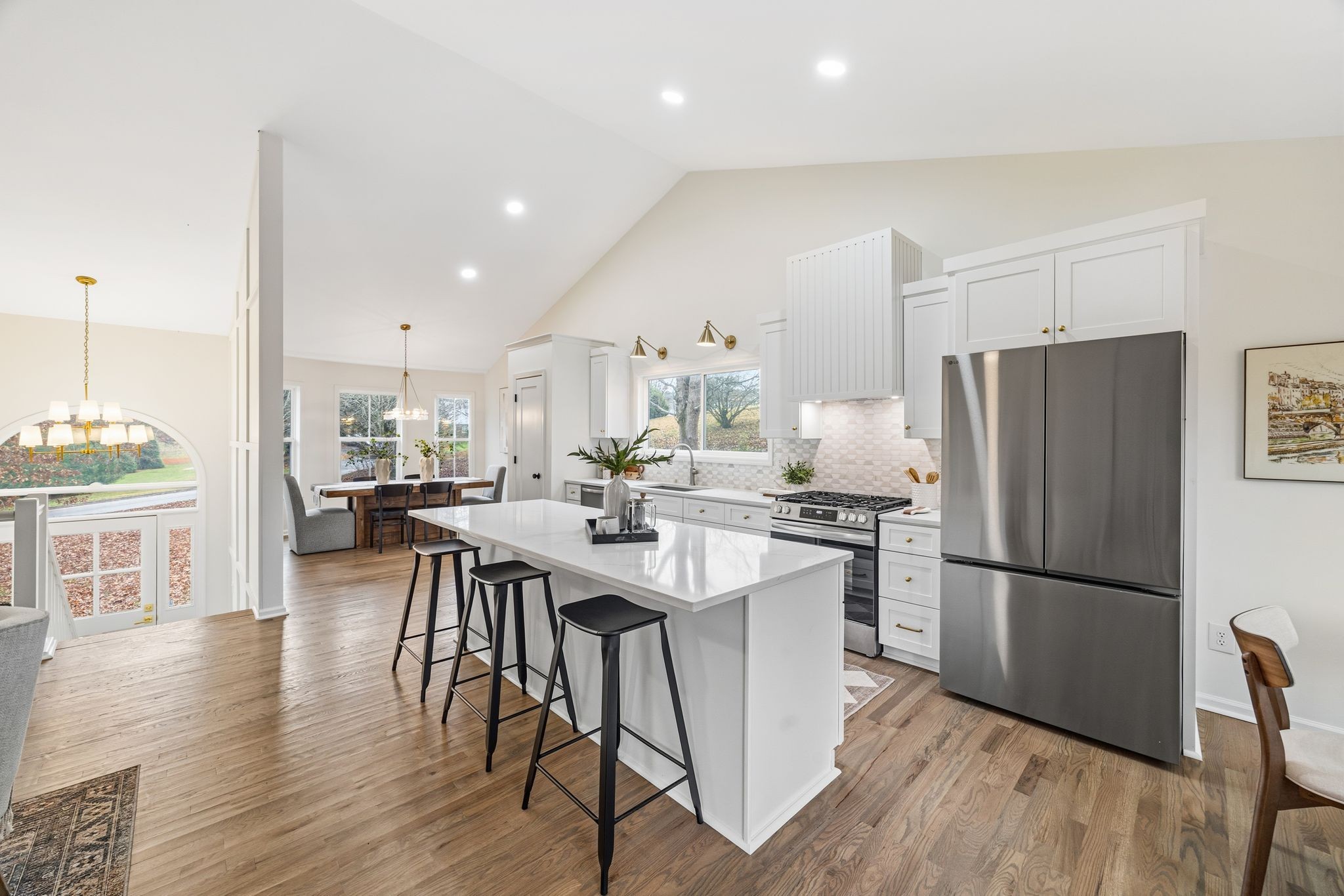 209 Pin Oak Court Spring Hill, TN 37174 - Photo 28 of 53 a kitchen with stainless steel appliances a dining table chairs stove refrigerator and cabinets