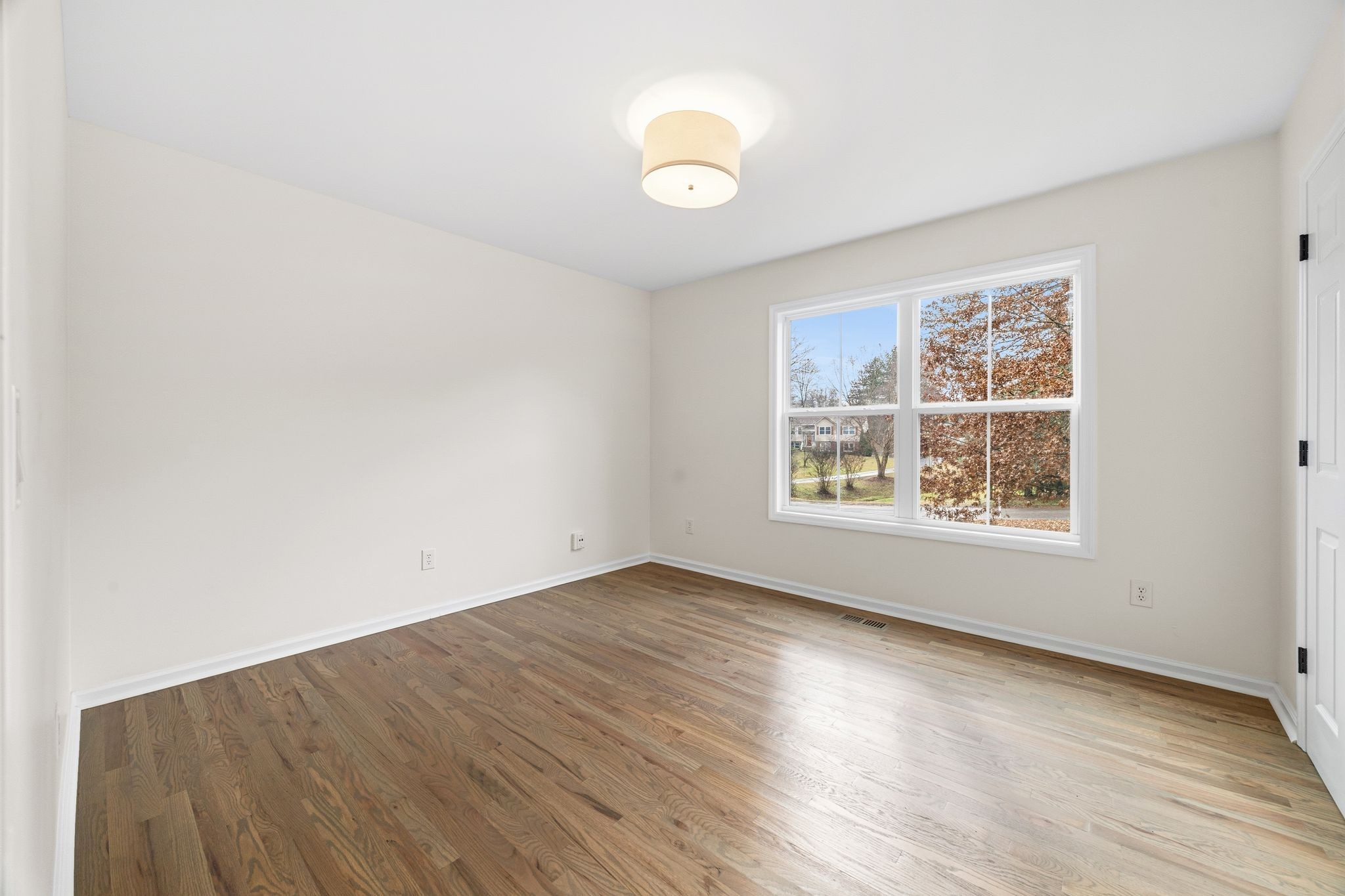 209 Pin Oak Court Spring Hill, TN 37174 - Photo 39 of 53 an empty room with wooden floor and windows