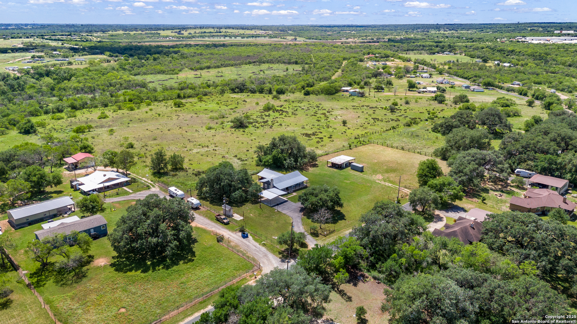18950 Southton Road Elmendorf, TX 78112 - Photo 12 of 16 an aerial view of residential houses with outdoor space and trees