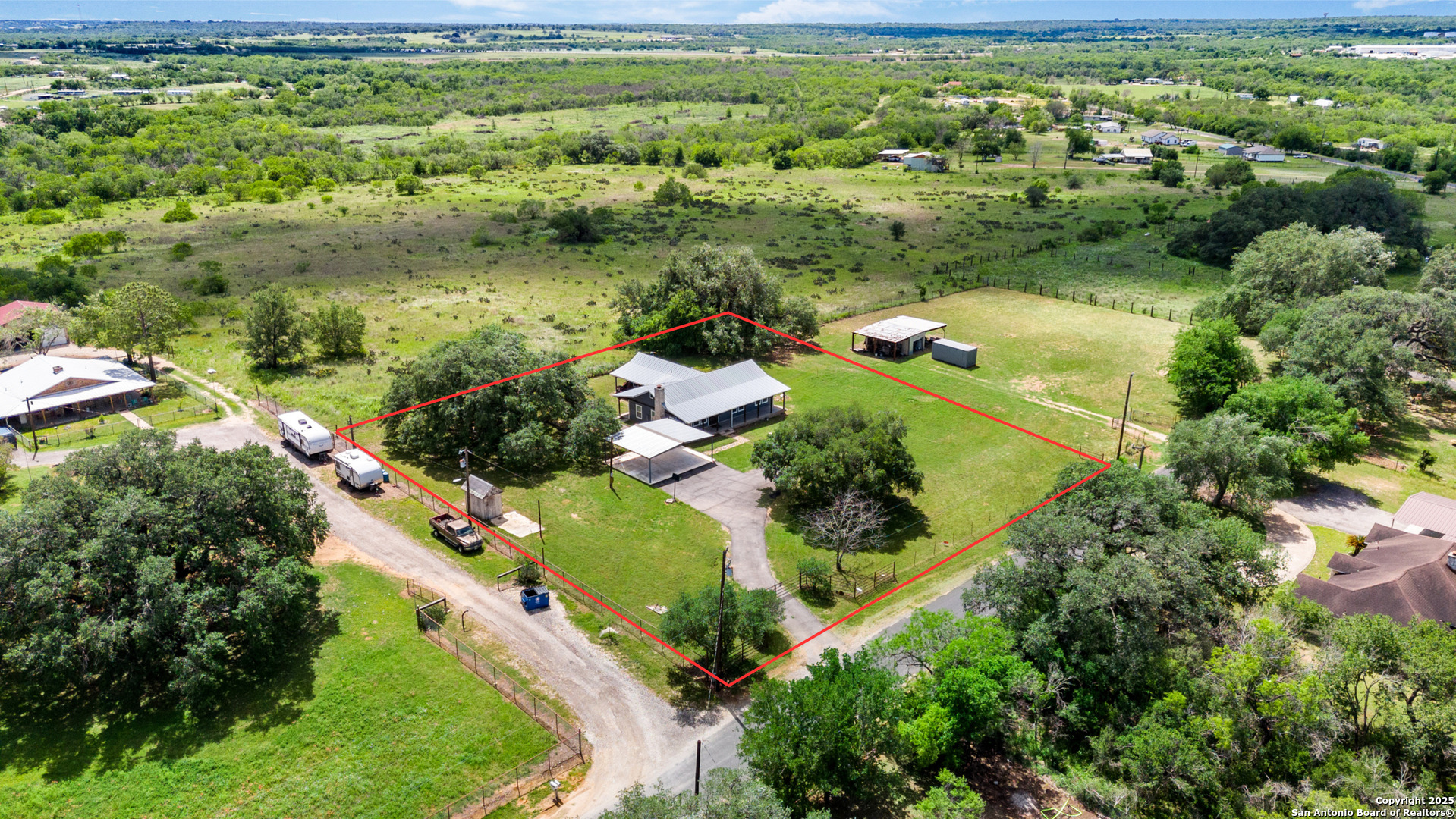 18950 Southton Road Elmendorf, TX 78112 - Photo 2 of 16 an aerial view of residential houses with outdoor space and trees