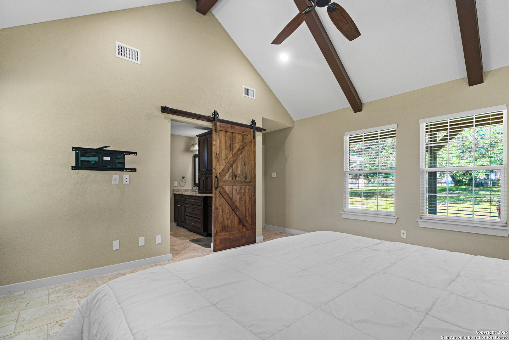 18950 Southton Road Elmendorf, TX 78112 - Photo 5 of 16 a bedroom with a bed and a window