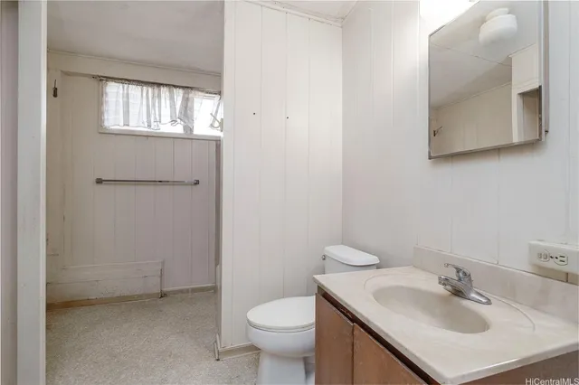 a bathroom with a sink toilet and mirror