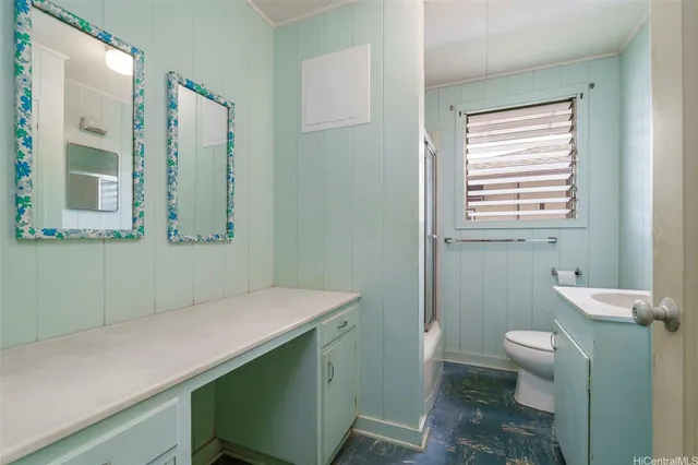 a bathroom with a sink a toilet and a mirror