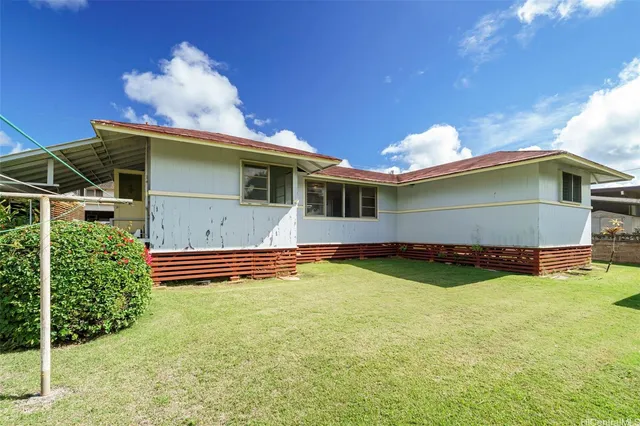 a view of a house with pool and a yard