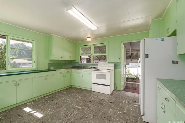 a kitchen with a stove a sink and a refrigerator