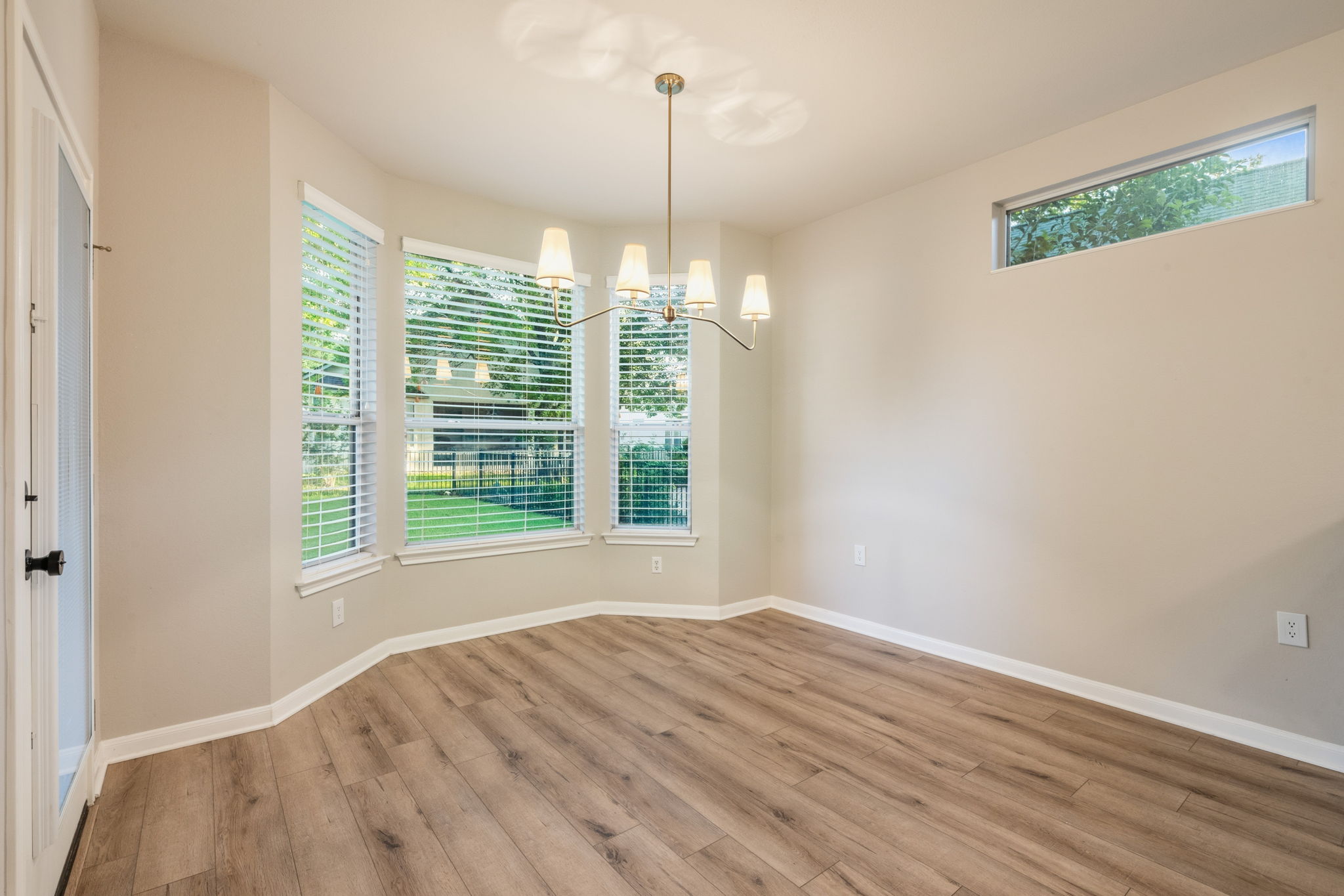 137 Trail Rider Way Georgetown, TX 78633 - Photo 8 of 29 Luminous dining area with wide-plank flooring and a contemporary chandelier.