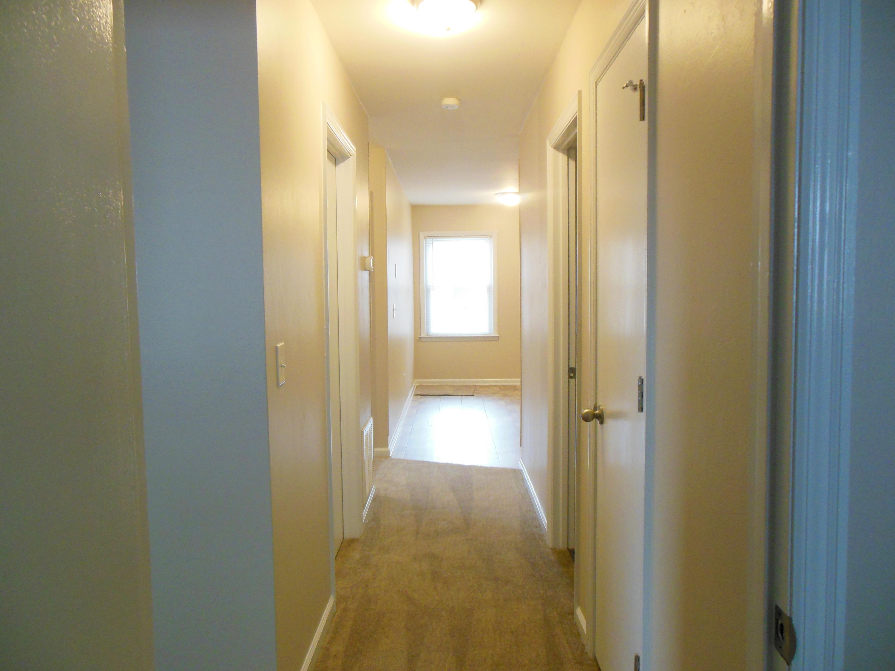 701 Riverland Road Southeast Roanoke, VA 24014 - Photo 24 of 33 a view of a hallway with wooden floor and a bathroom