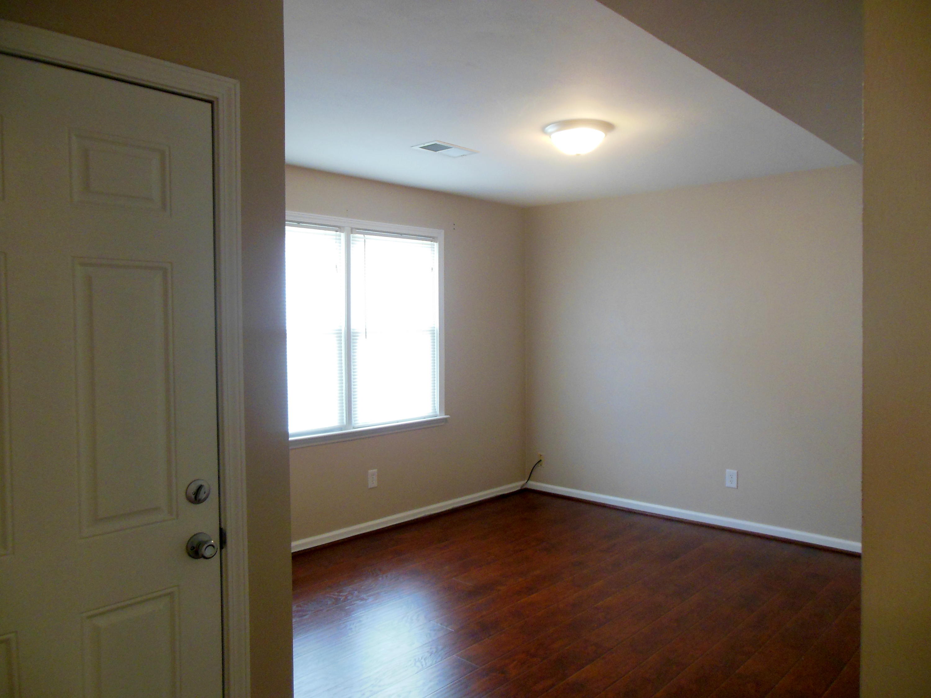 701 Riverland Road Southeast Roanoke, VA 24014 - Photo 7 of 33 an empty room with wooden floor and windows
