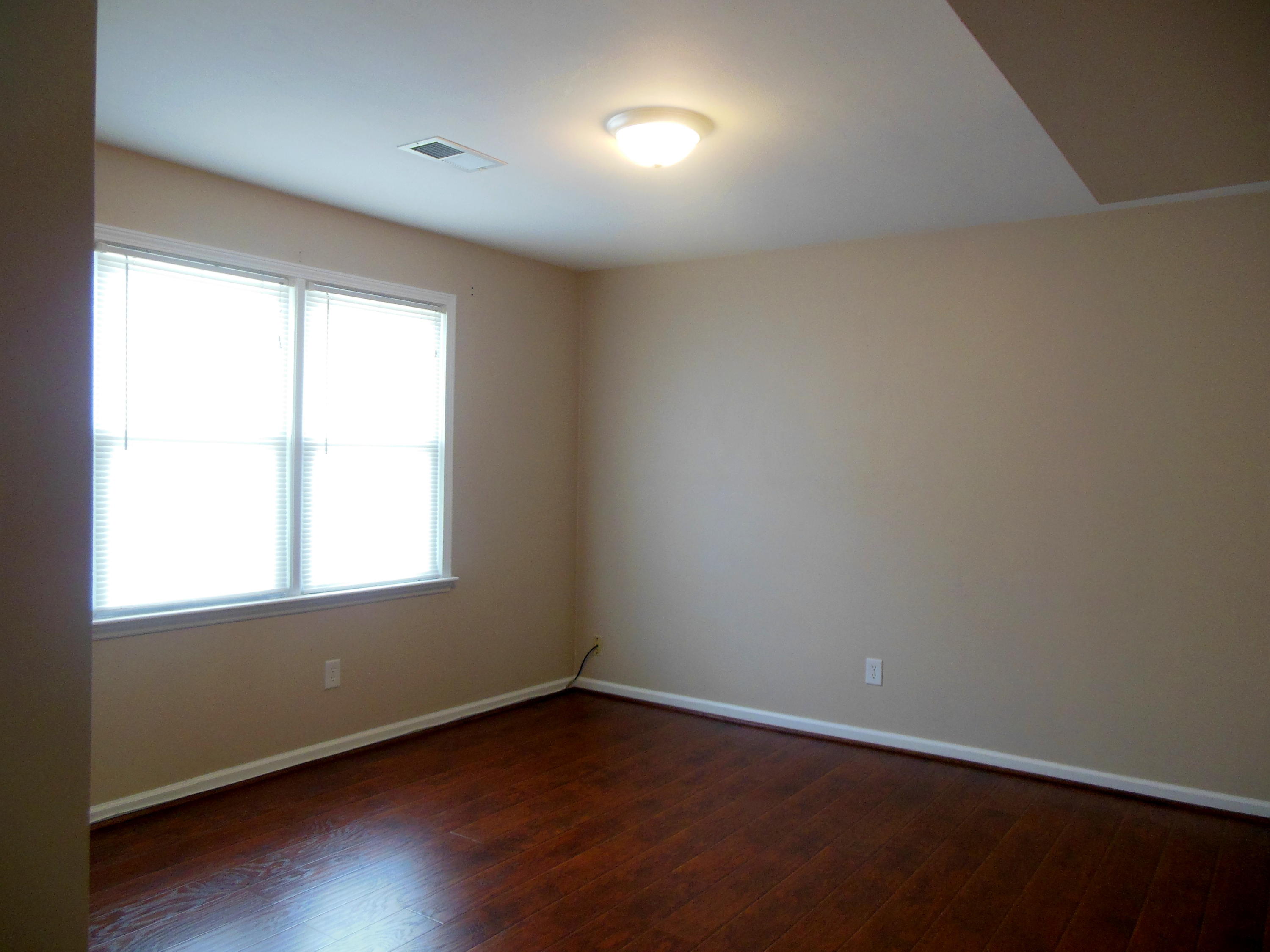 701 Riverland Road Southeast Roanoke, VA 24014 - Photo 8 of 33 an empty room with wooden floor and windows