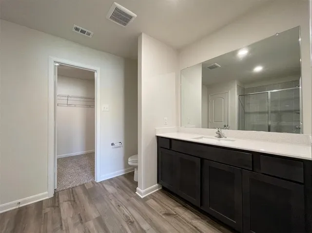 a bathroom with a double vanity sink and mirror