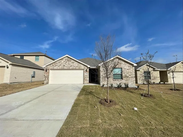 a view of a house with a yard and garage