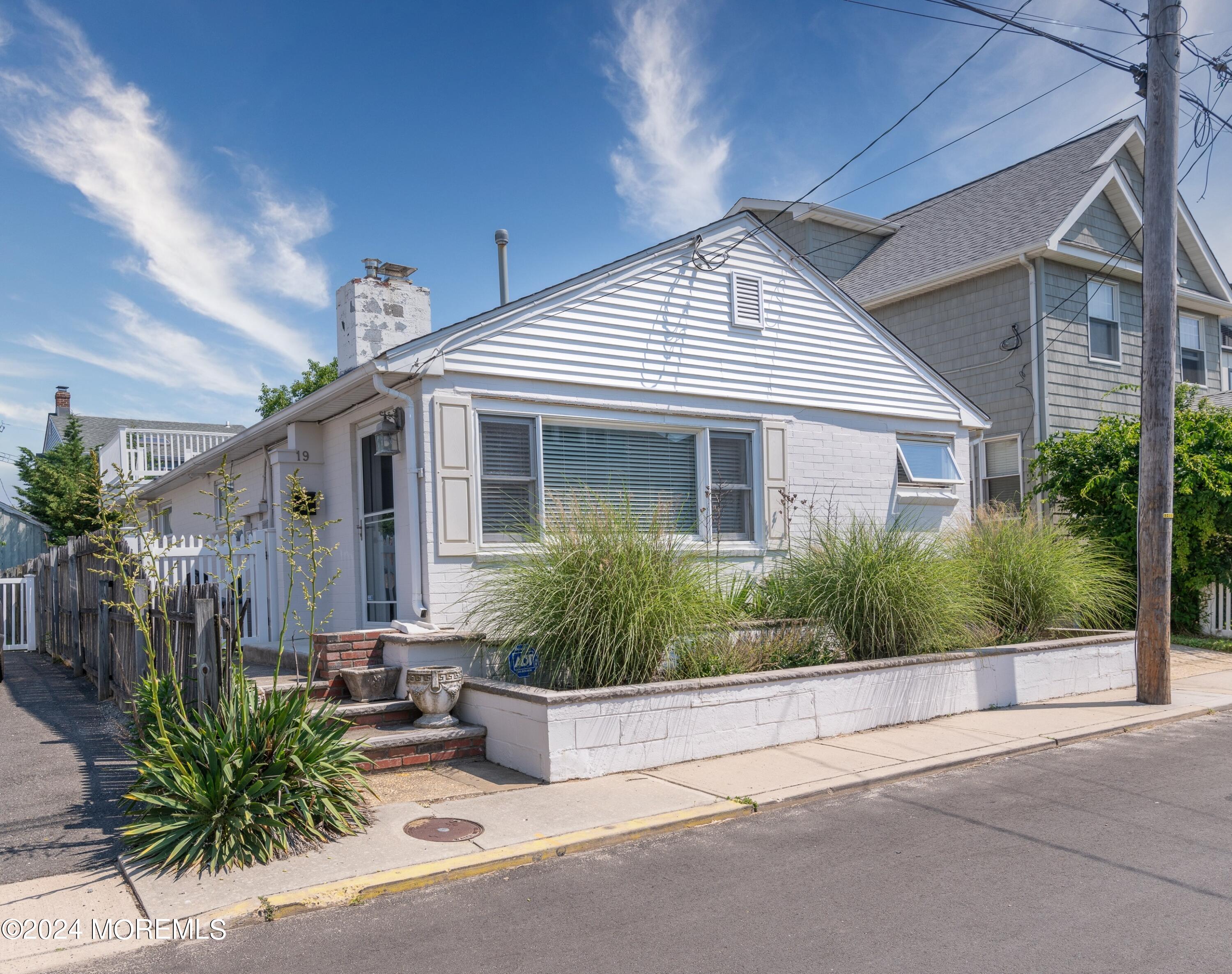 19 Via Ripa Way Sea Bright, NJ 07760 - Photo 2 of 41 a front view of a house with a garden