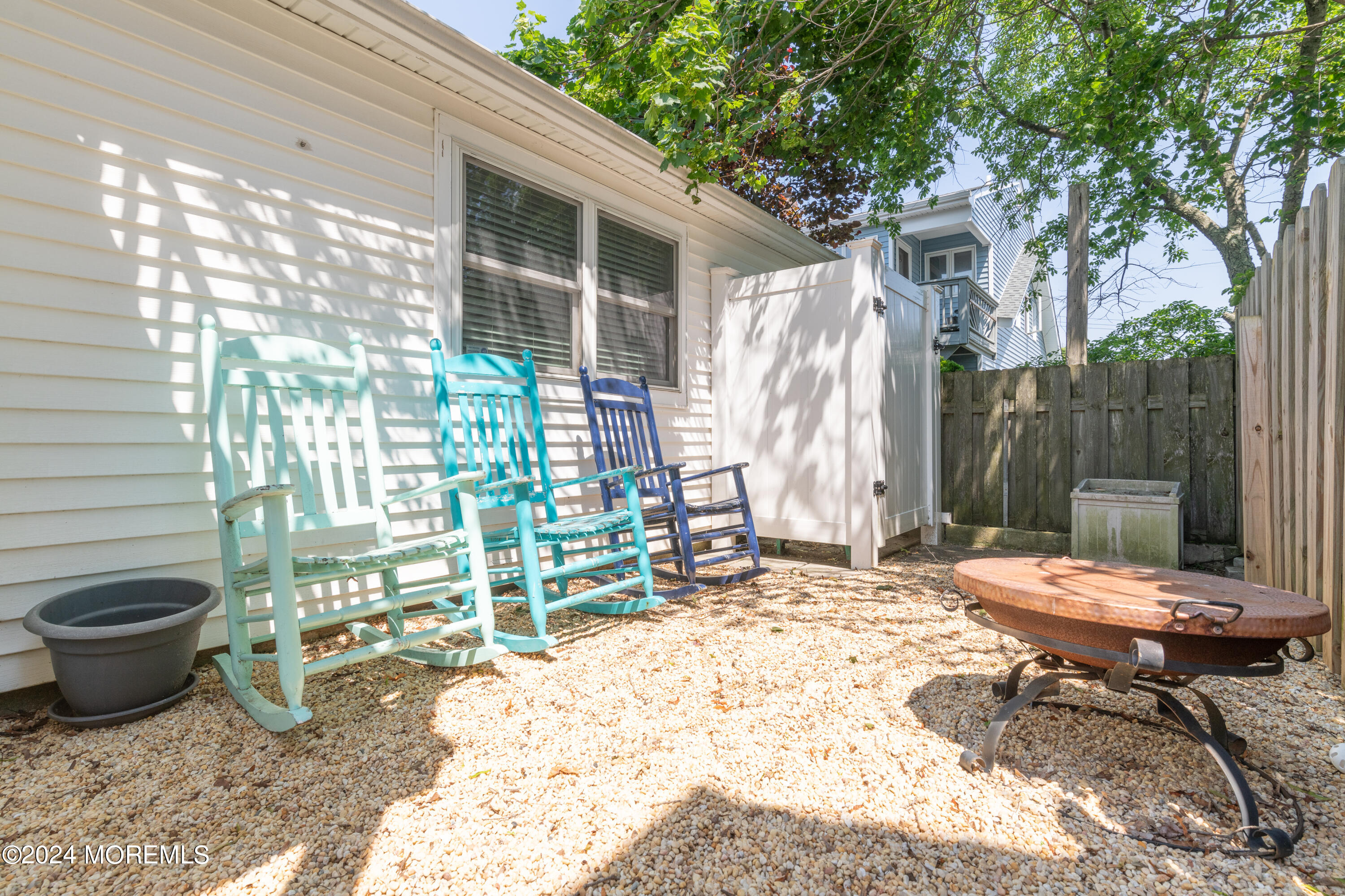 19 Via Ripa Way Sea Bright, NJ 07760 - Photo 29 of 41 a backyard of a house with table and chairs