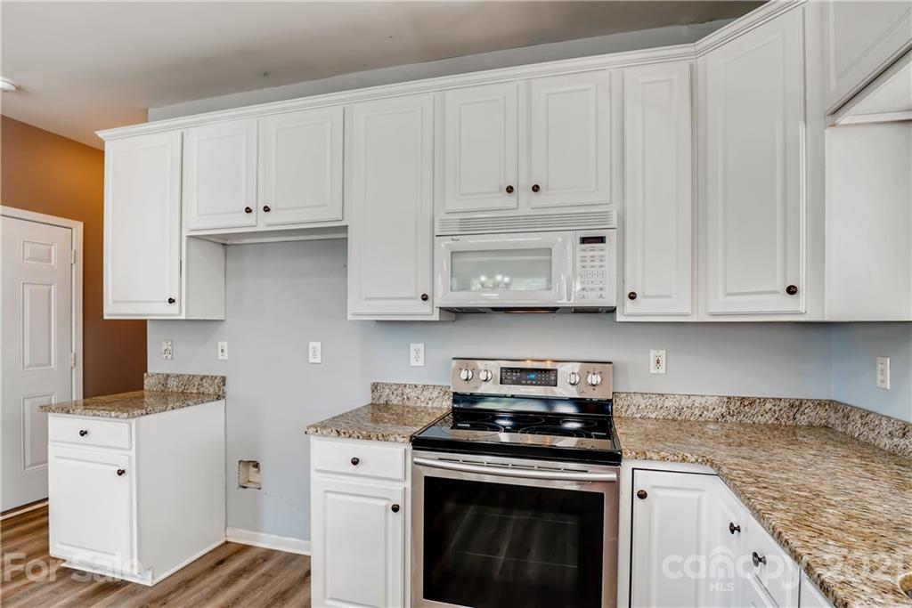 4912 Missi Lane Fort Mill, SC 29708 - Photo 13 of 33 a kitchen with white cabinets and white appliances