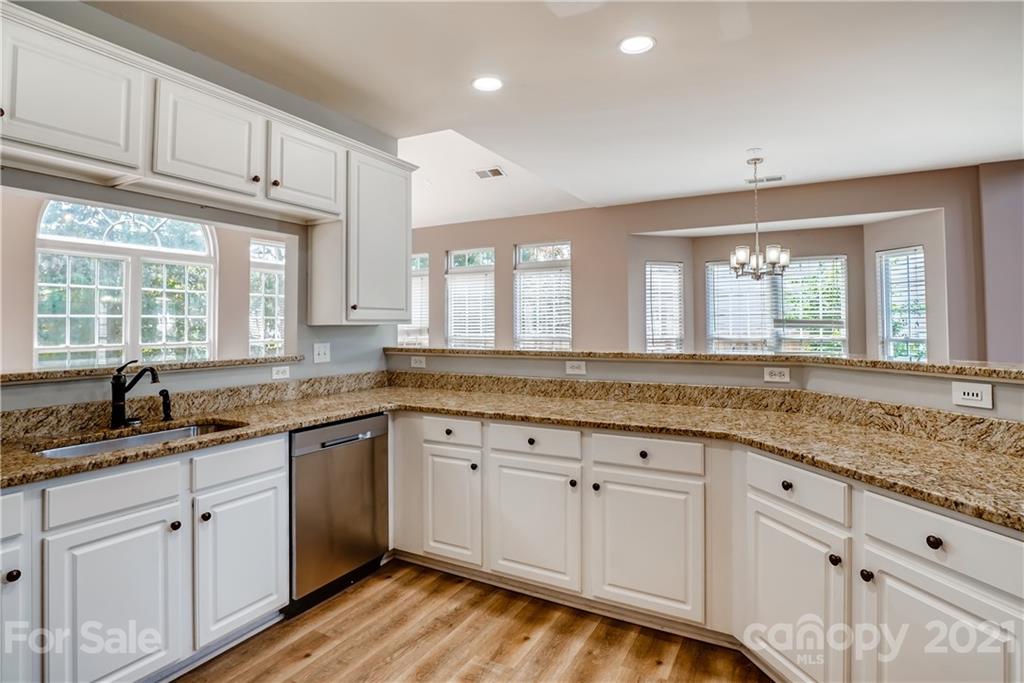 4912 Missi Lane Fort Mill, SC 29708 - Photo 14 of 33 a kitchen with granite countertop white cabinets white appliances and sink