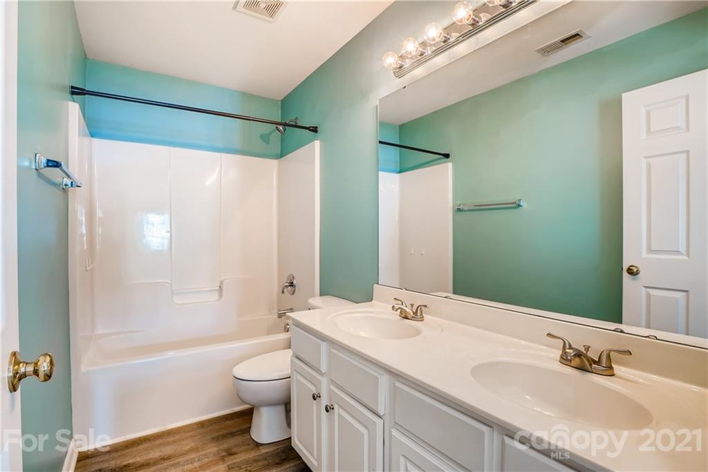 4912 Missi Lane Fort Mill, SC 29708 - Photo 19 of 33 a bathroom with a granite countertop sink toilet and shower