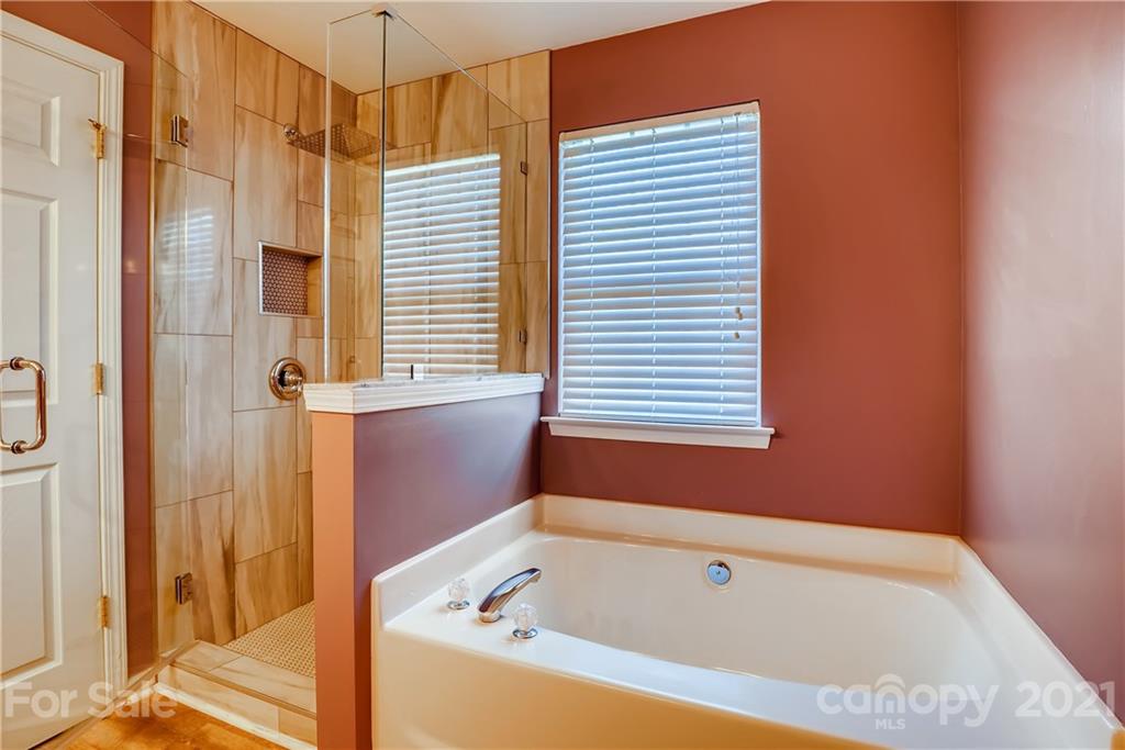 4912 Missi Lane Fort Mill, SC 29708 - Photo 23 of 33 a bathroom with a bathtub and shower