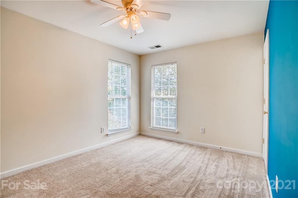 4912 Missi Lane Fort Mill, SC 29708 - Photo 27 of 33 an empty room with chandelier fan and windows