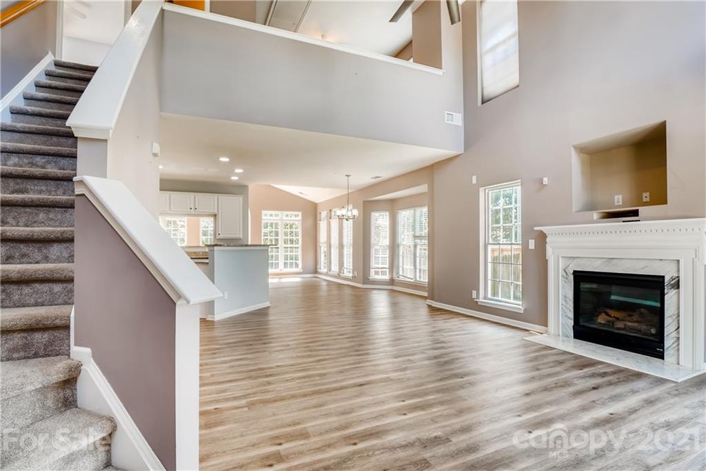 4912 Missi Lane Fort Mill, SC 29708 - Photo 4 of 33 a view of an empty room with wooden floor and a fireplace
