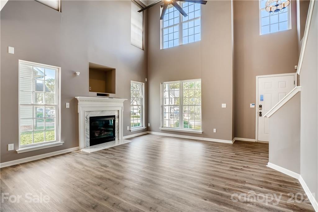 4912 Missi Lane Fort Mill, SC 29708 - Photo 6 of 33 a view of an empty room with wooden floor fireplace and a window