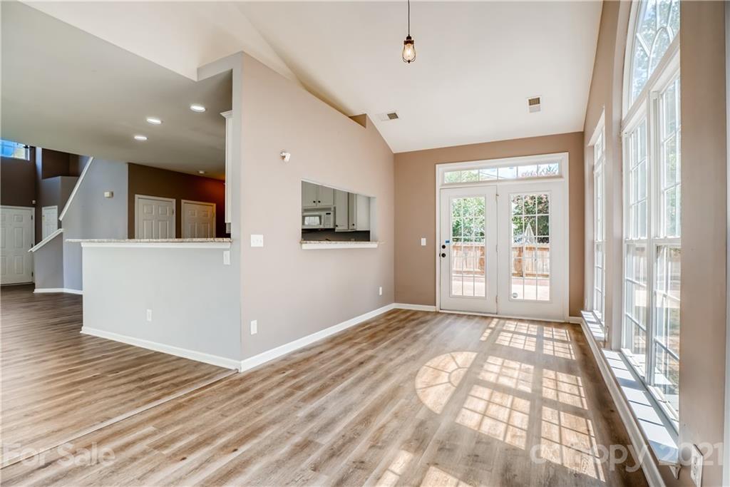 4912 Missi Lane Fort Mill, SC 29708 - Photo 8 of 33 a view of a big room with wooden floor and windows