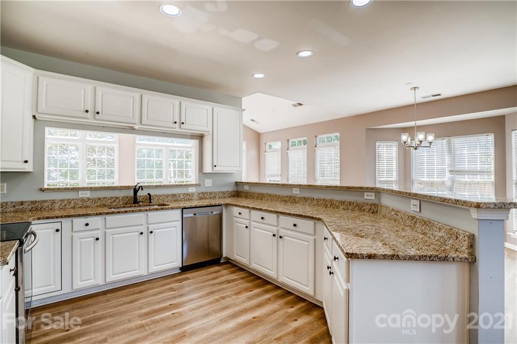 4912 Missi Lane Fort Mill, SC 29708 - Photo 10 of 33 a kitchen with granite countertop sink stove and cabinets