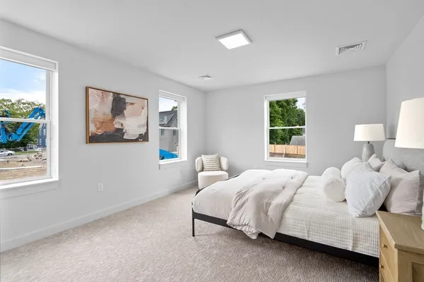 a bedroom with a bed painting and window