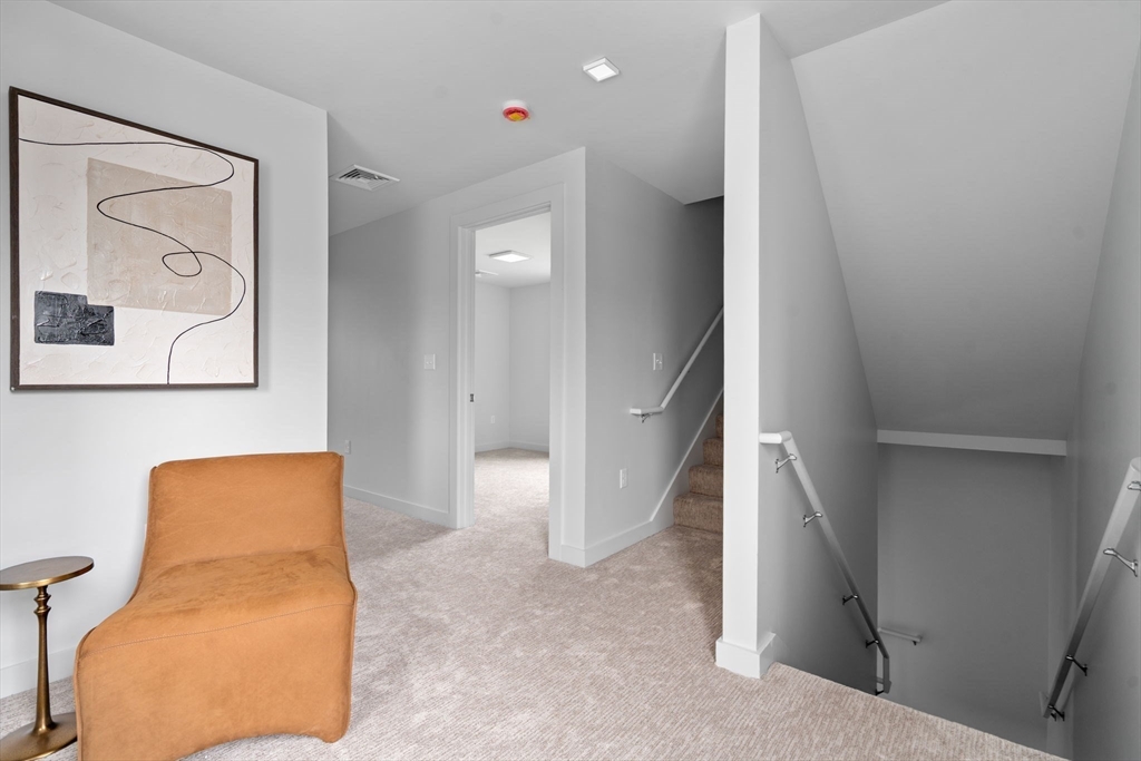 3 B Wilson Street, Unit 3B Natick, MA 01760 - Photo 18 of 33 a view of hallway with paintings on the wall