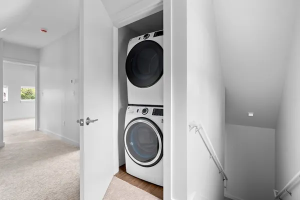 a view of a hallway with washer and dryer