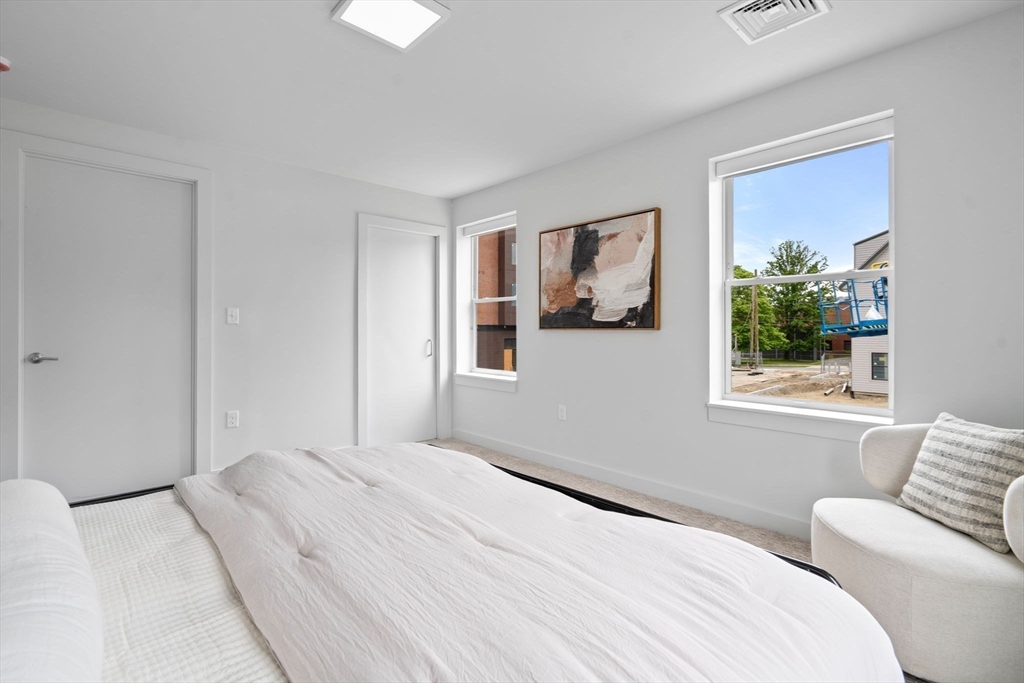 3 B Wilson Street, Unit 3B Natick, MA 01760 - Photo 21 of 33 a bedroom with a bed and a painting on the wall