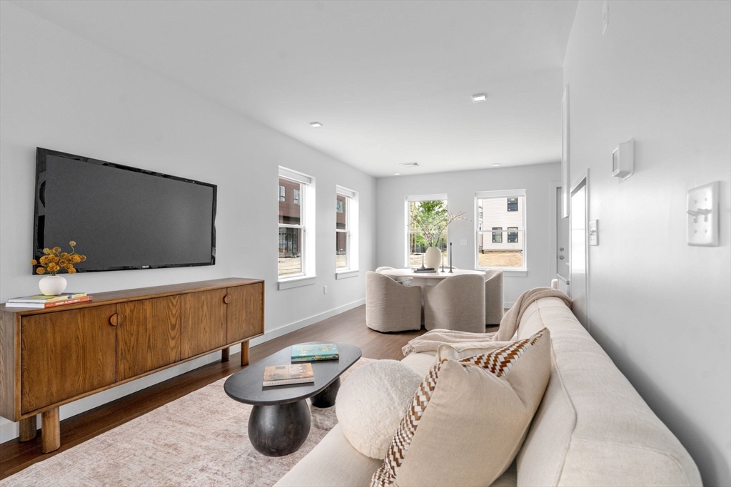 3 B Wilson Street, Unit 3B Natick, MA 01760 - Photo 5 of 33 a living room with furniture and a flat screen tv