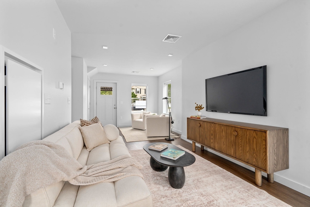 3 B Wilson Street, Unit 3B Natick, MA 01760 - Photo 6 of 33 a living room with furniture and a flat screen tv