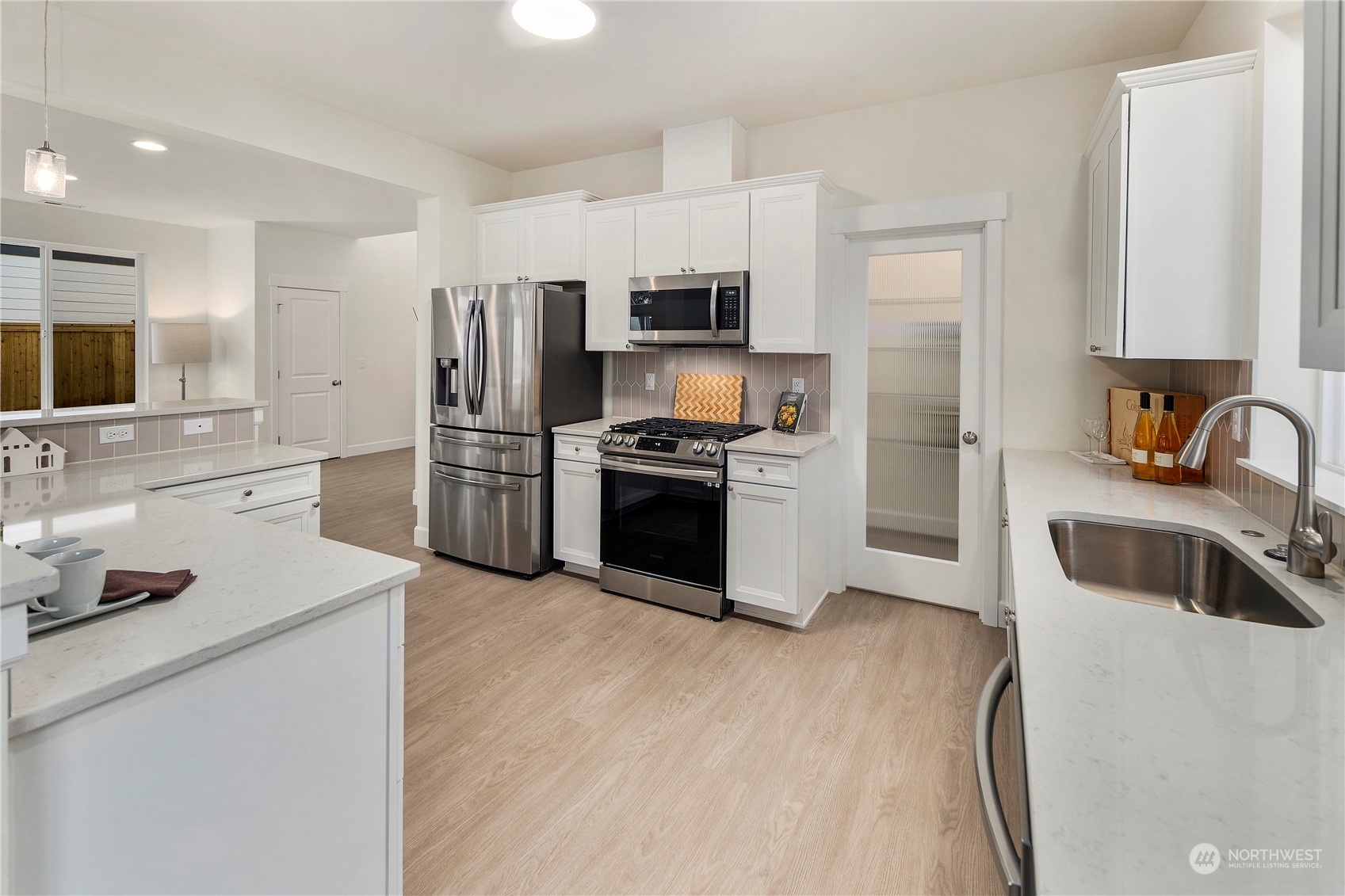 10969 Lot 8 Se 165th Street Renton, WA 98055 - Photo 11 of 38 a kitchen with kitchen island a sink stove and refrigerator