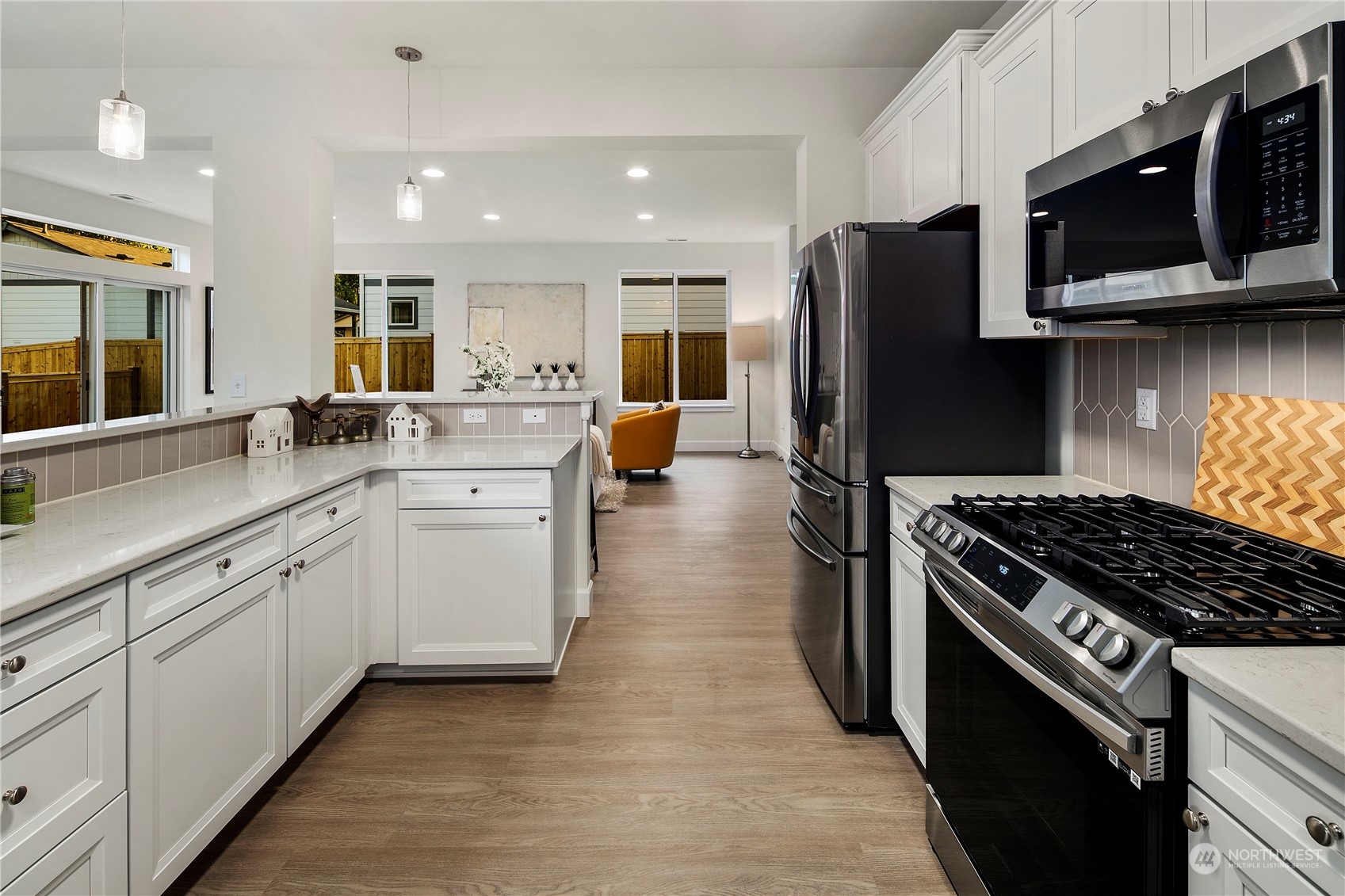 10969 Lot 8 Se 165th Street Renton, WA 98055 - Photo 12 of 38 a kitchen with stainless steel appliances granite countertop a stove top oven microwave and refrigerator