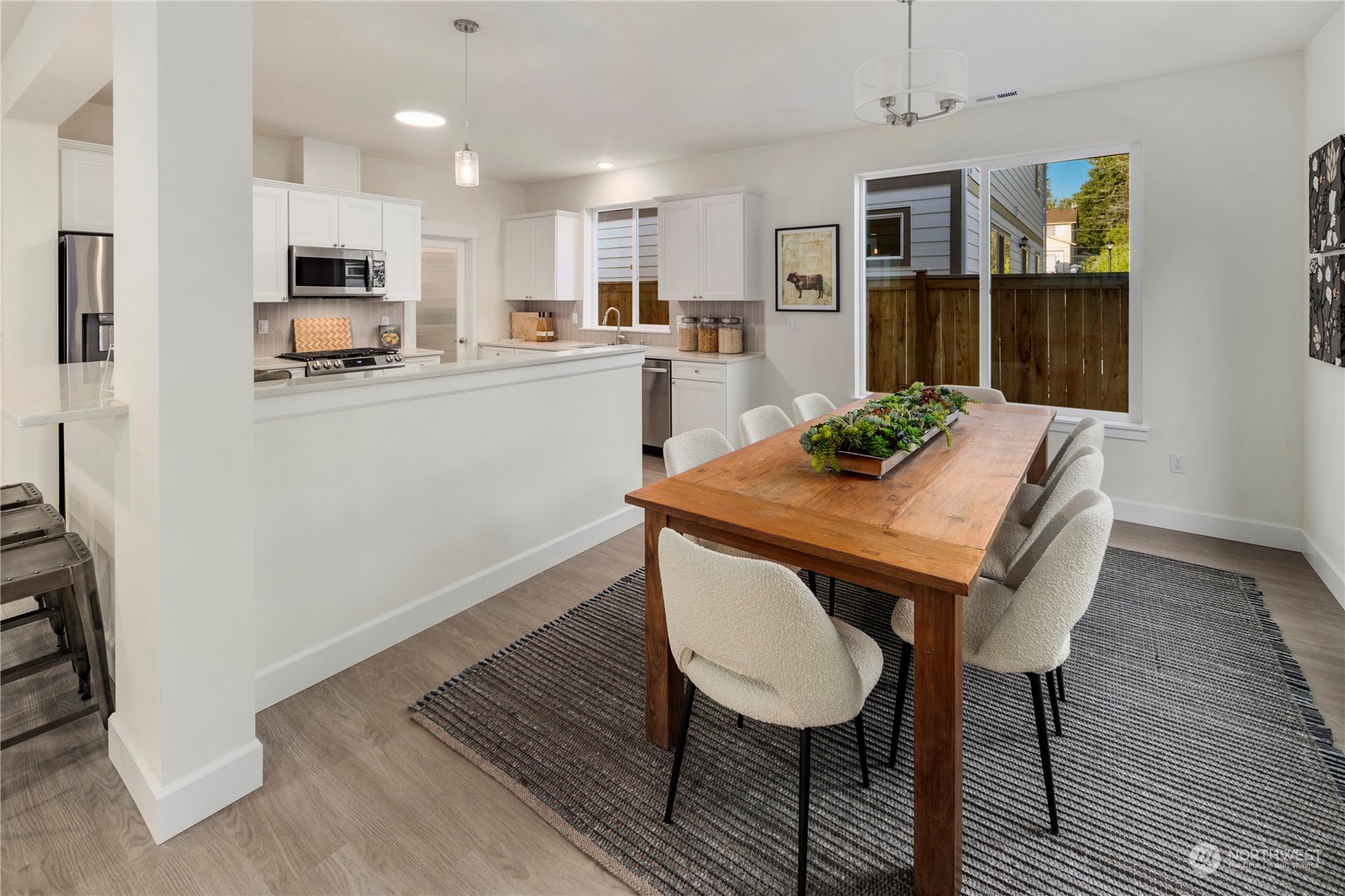 10969 Lot 8 Se 165th Street Renton, WA 98055 - Photo 13 of 38 a kitchen with a table chairs refrigerator and microwave