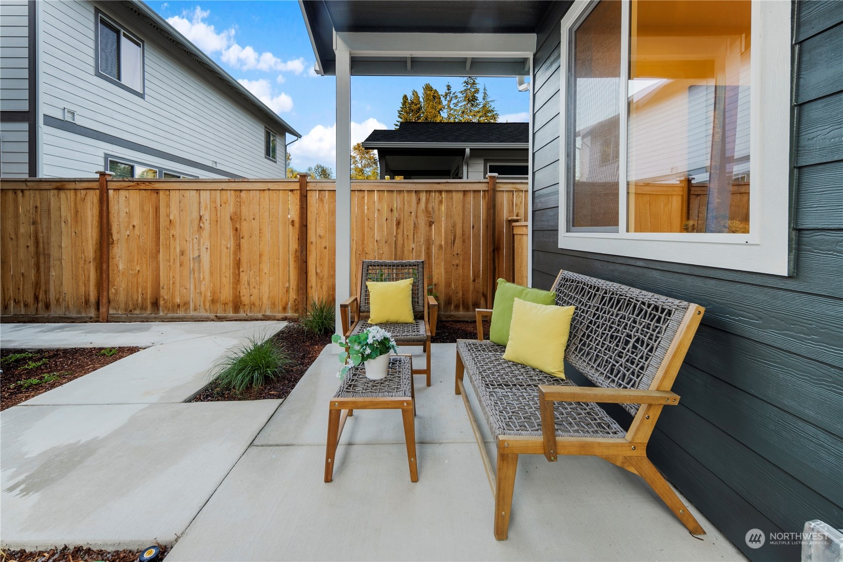 10969 Lot 8 Se 165th Street Renton, WA 98055 - Photo 29 of 38 a view of a patio with a table and chairs and potted plants