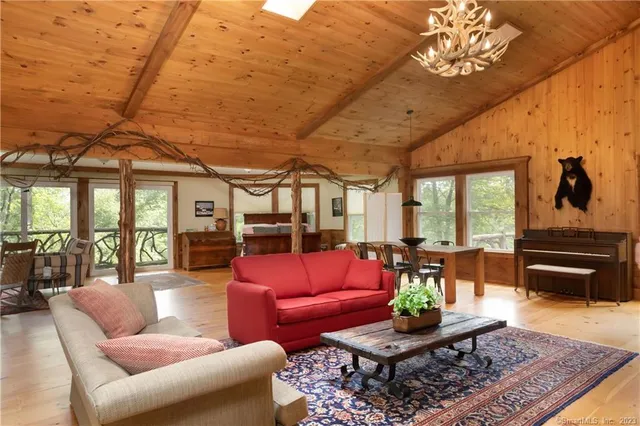 a living room with furniture a rug and a chandelier
