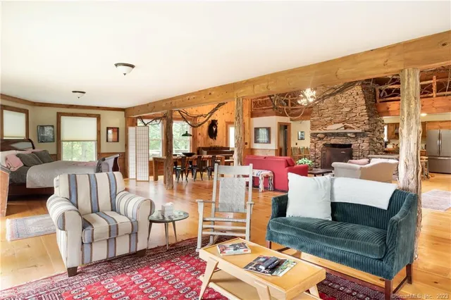 a living room with furniture and a floor to ceiling window