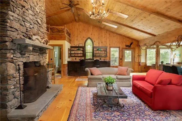 a living room with furniture fireplace and a table