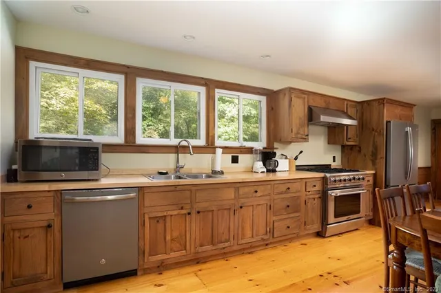 a kitchen with a sink stove and cabinets