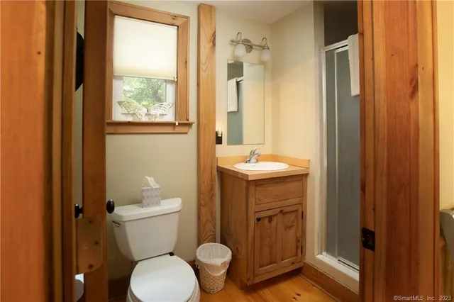 a bathroom with a toilet a sink and a window