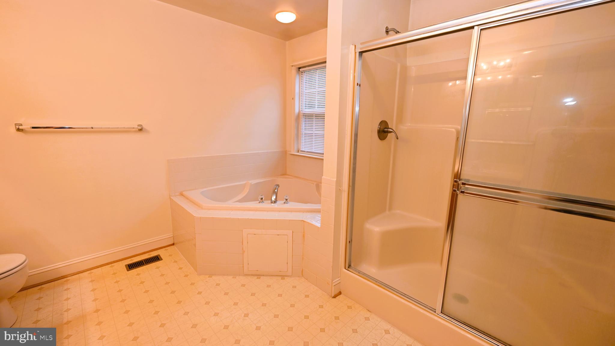 11258 Wildmeadows Street Waldorf, MD 20601 - Photo 15 of 33 a bathroom with a bathtub and a shower