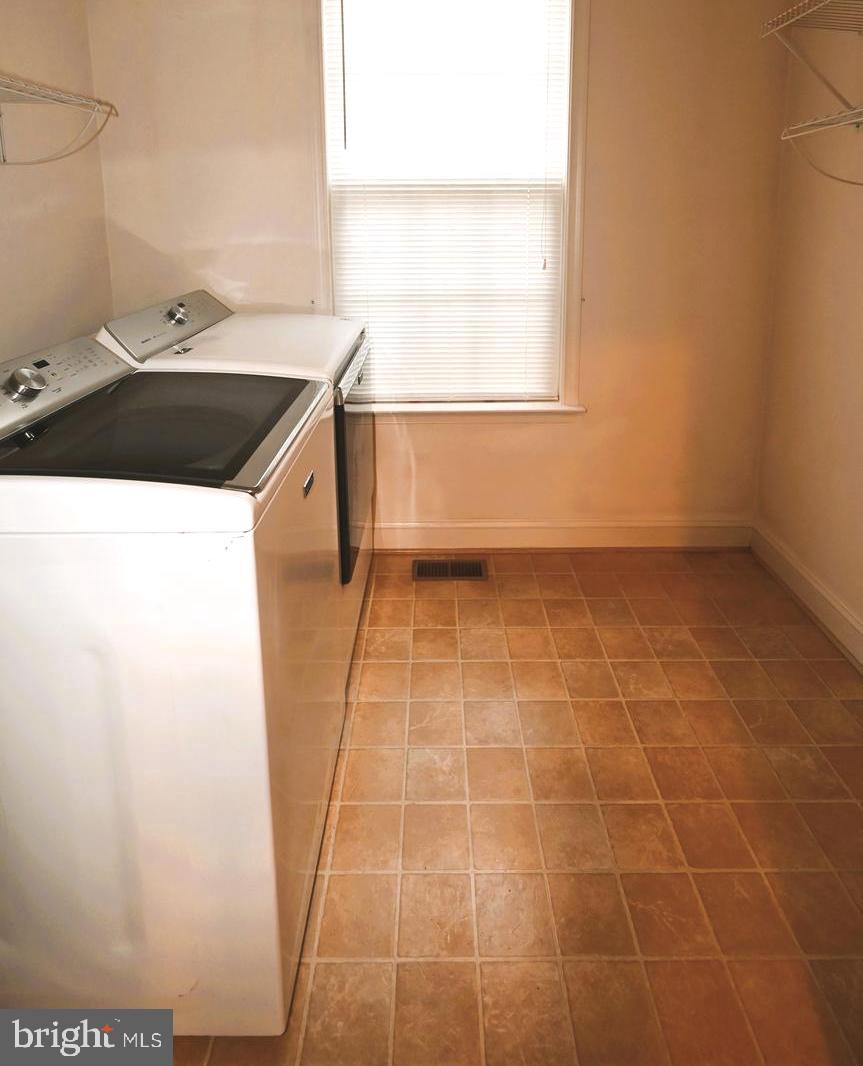 11258 Wildmeadows Street Waldorf, MD 20601 - Photo 20 of 33 a kitchen with a sink a stove and a window